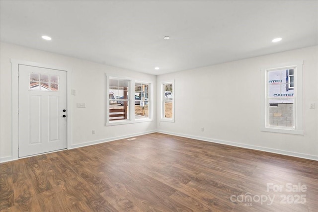 foyer entrance with baseboards, wood finished floors, and recessed lighting