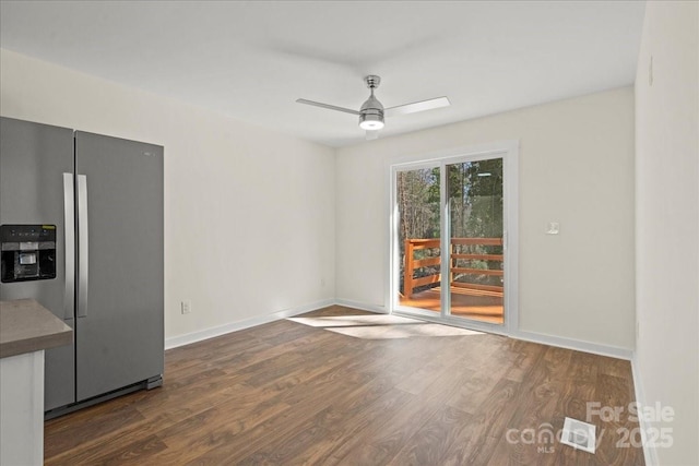 interior space featuring ceiling fan, baseboards, and wood finished floors