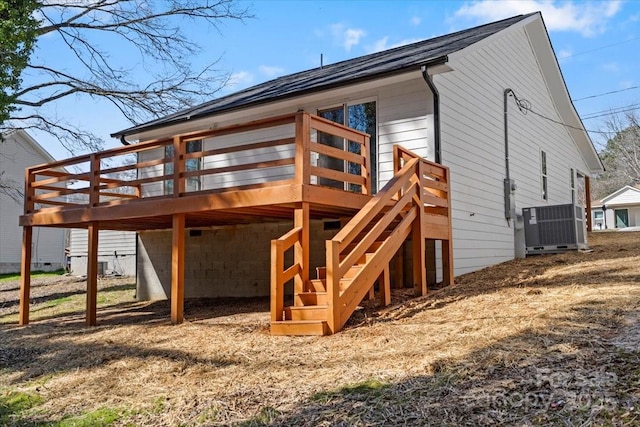 exterior space featuring a deck, stairway, and central air condition unit