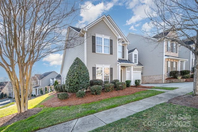 view of front of house with a front yard and a garage