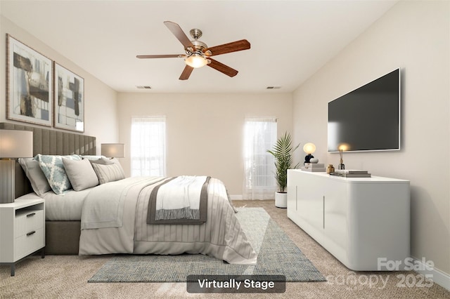 carpeted bedroom featuring multiple windows and ceiling fan