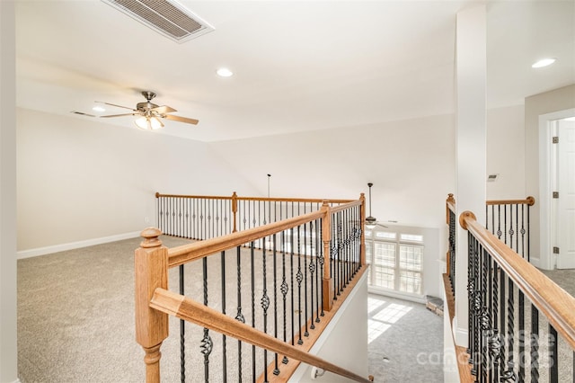 hall with light colored carpet