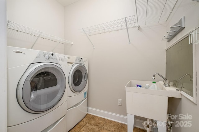 clothes washing area with sink and washing machine and clothes dryer