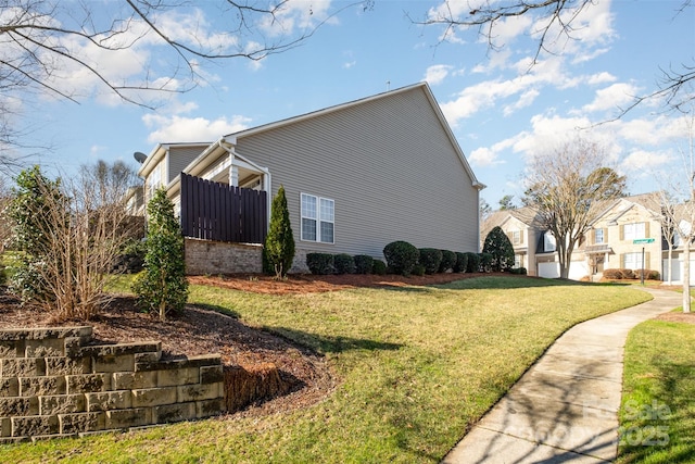 view of side of property with a lawn