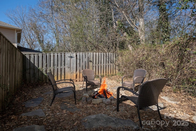 view of patio / terrace featuring an outdoor fire pit and a fenced backyard