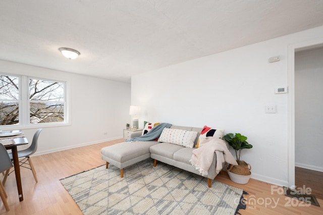 living room featuring wood finished floors and baseboards