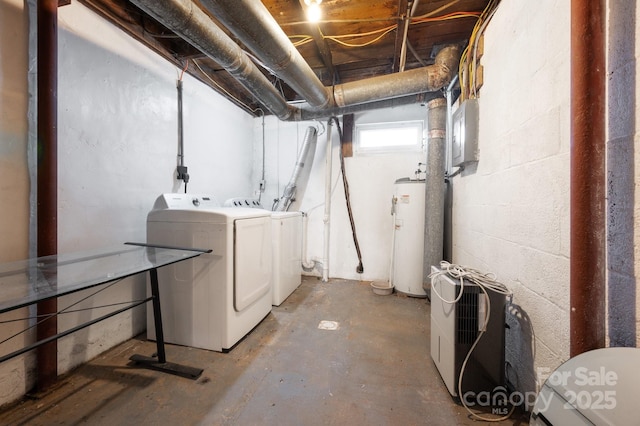 interior space with washing machine and dryer, gas water heater, concrete block wall, and laundry area