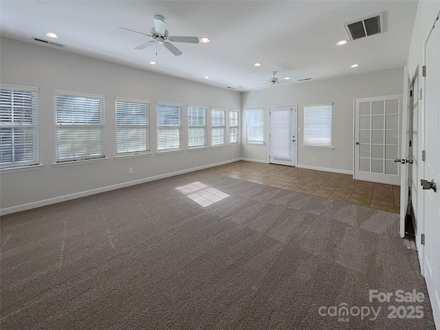 carpeted spare room with ceiling fan