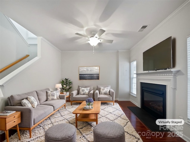 living room with ceiling fan, dark wood-type flooring, and ornamental molding