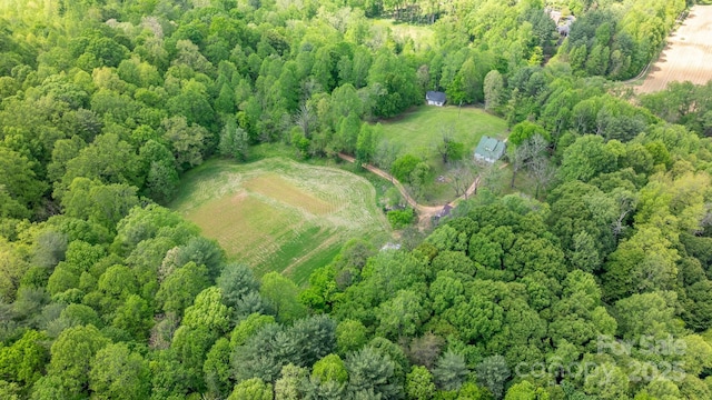 drone / aerial view featuring a wooded view