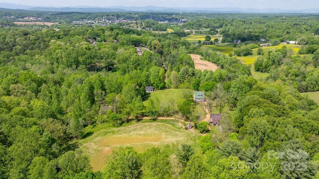 drone / aerial view featuring a view of trees