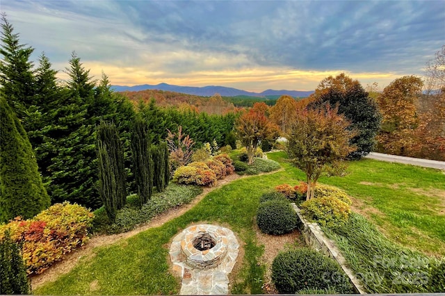 exterior space featuring a mountain view and a fire pit