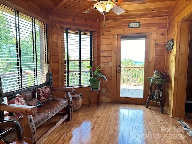 202 Panorama Dr, Nebo, NC 28761 - living area with light wood-style floors, wood walls, healthy amount of natural light, and a ceiling fan