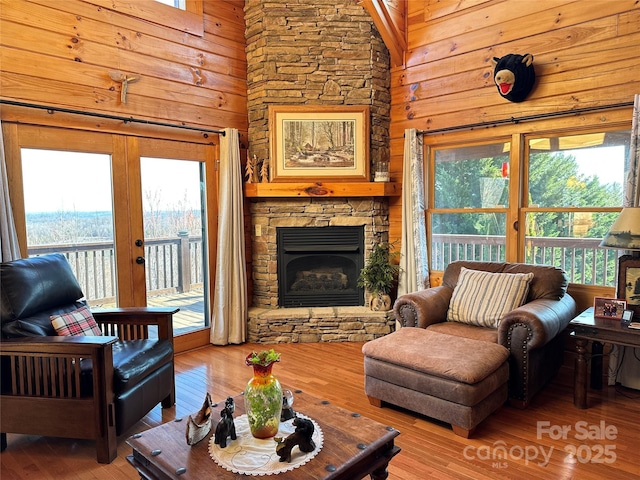 202 Panorama Dr, Nebo, NC 28761 - living room featuring hardwood / wood-style flooring, wood walls, a high ceiling, and a fireplace
