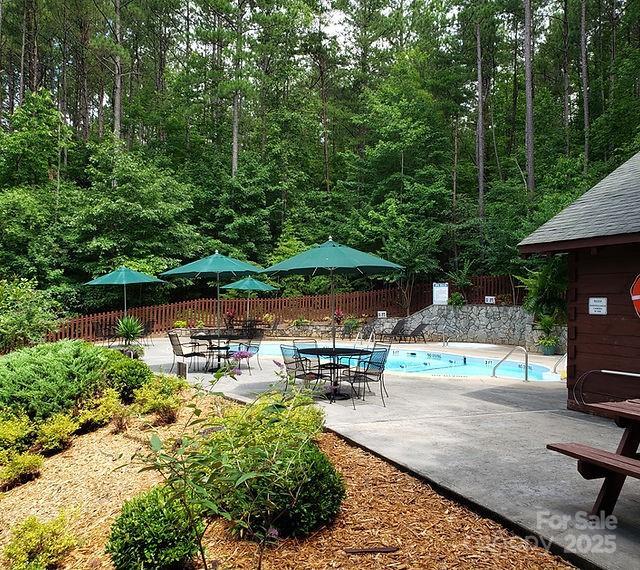 202 Panorama Dr, Nebo, NC 28761 - community pool featuring a patio area, fence, and a view of trees