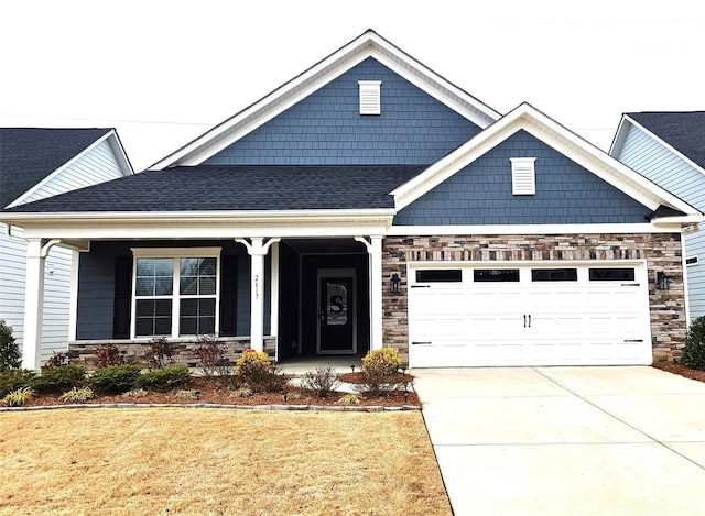 craftsman house featuring concrete driveway, stone siding, roof with shingles, and an attached garage