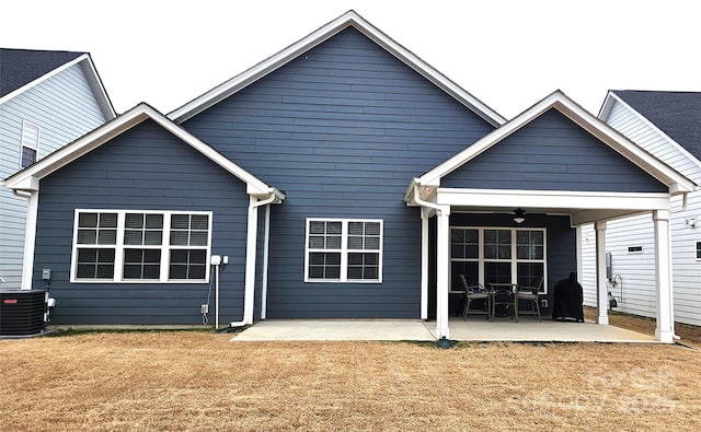 back of property with a yard, central AC, a patio, and ceiling fan