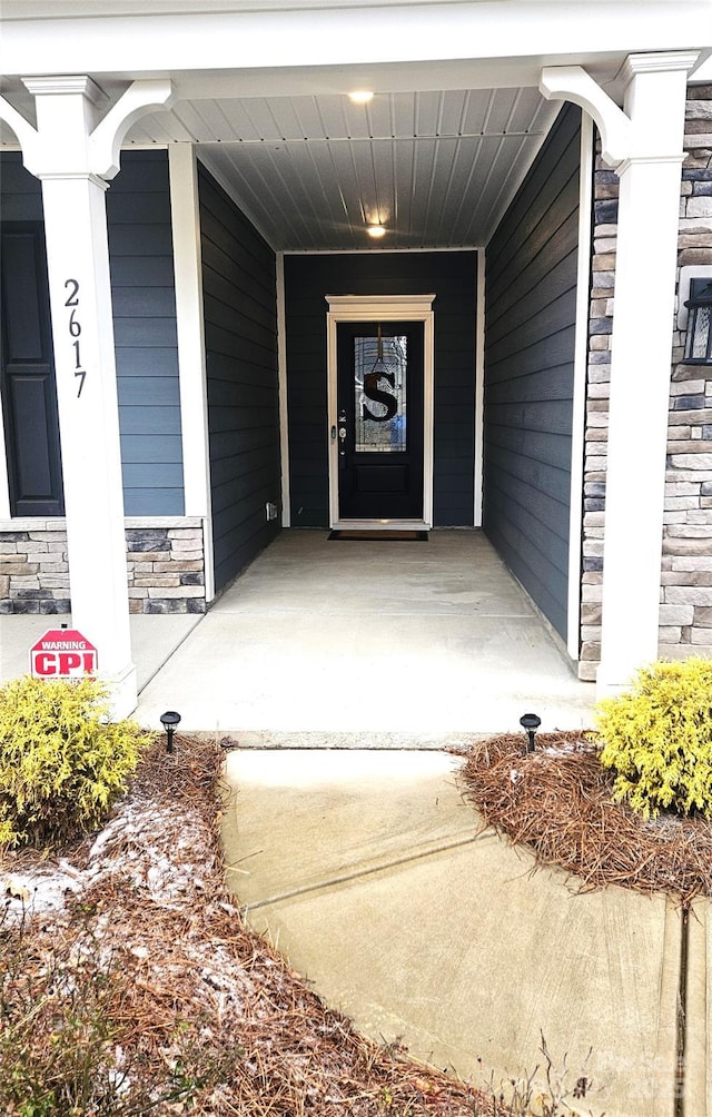 entrance to property with stone siding