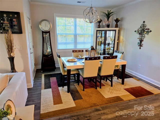 2617 Manor Stone Way, Indian Trail, NC 28079 - dining space with baseboards, an inviting chandelier, ornamental molding, and wood finished floors