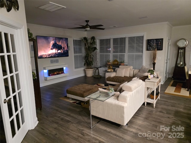 2617 Manor Stone Way, Indian Trail, NC 28079 - living room with a ceiling fan, a warm lit fireplace, crown molding, and wood finished floors