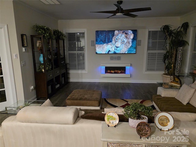 2617 Manor Stone Way, Indian Trail, NC 28079 - living room with a ceiling fan, crown molding, wood finished floors, a warm lit fireplace, and baseboards
