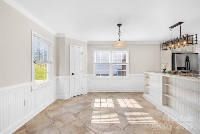 1133 Bloom Wood Ln, Matthews, NC 28105 - unfurnished dining area featuring a wainscoted wall, ornamental molding, and light tile patterned floors