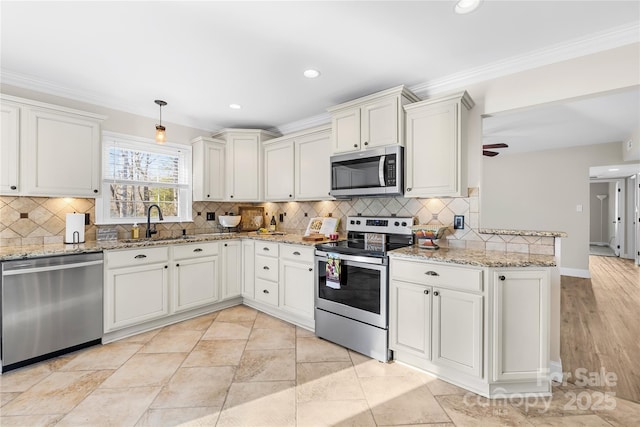 1133 Bloom Wood Ln, Matthews, NC 28105 - kitchen featuring light stone counters, a sink, decorative backsplash, appliances with stainless steel finishes, and ornamental molding