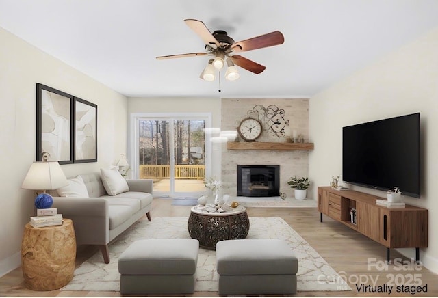 1133 Bloom Wood Ln, Matthews, NC 28105 - living room featuring a ceiling fan, a brick fireplace, and light wood-style flooring