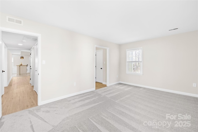 1133 Bloom Wood Ln, Matthews, NC 28105 - carpeted spare room with baseboards and visible vents