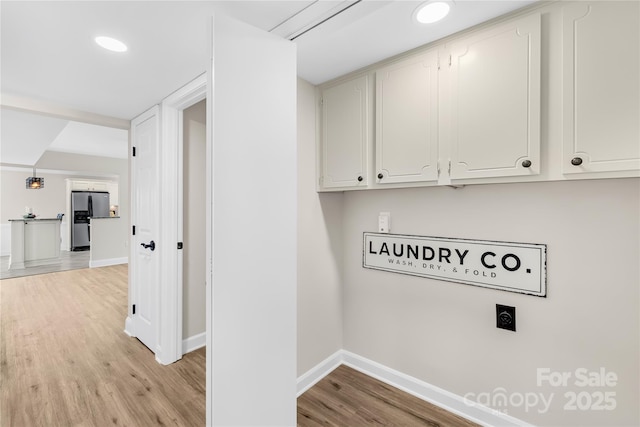 1133 Bloom Wood Ln, Matthews, NC 28105 - laundry area with electric dryer hookup, light wood-style floors, cabinet space, baseboards, and recessed lighting