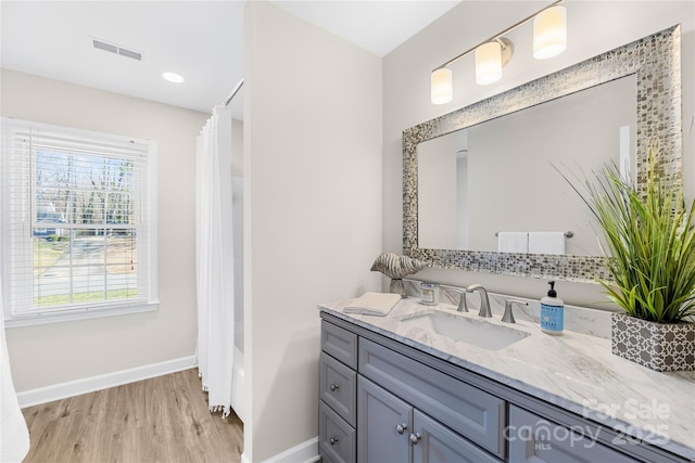 1133 Bloom Wood Ln, Matthews, NC 28105 - bathroom featuring wood finished floors, visible vents, vanity, baseboards, and a shower with shower curtain