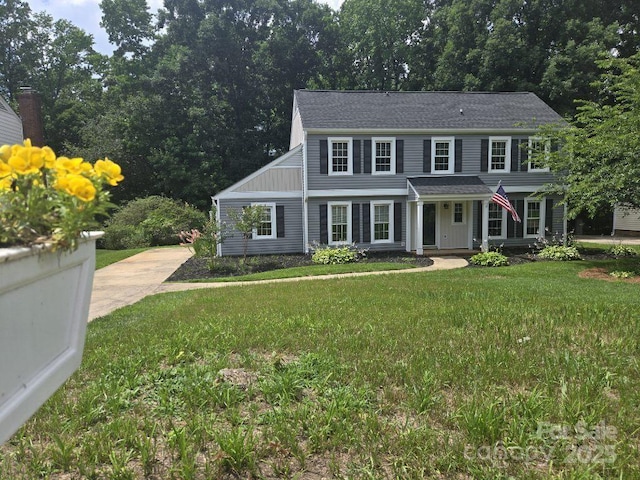 1133 Bloom Wood Ln, Matthews, NC 28105 - view of front of home featuring a front lawn, concrete driveway, a shingled roof, and board and batten siding