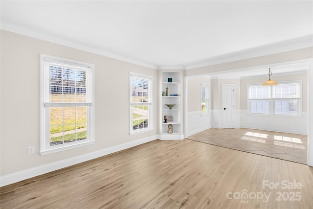 1133 Bloom Wood Ln, Matthews, NC 28105 - unfurnished living room with wood finished floors, ornamental molding, and built in shelves