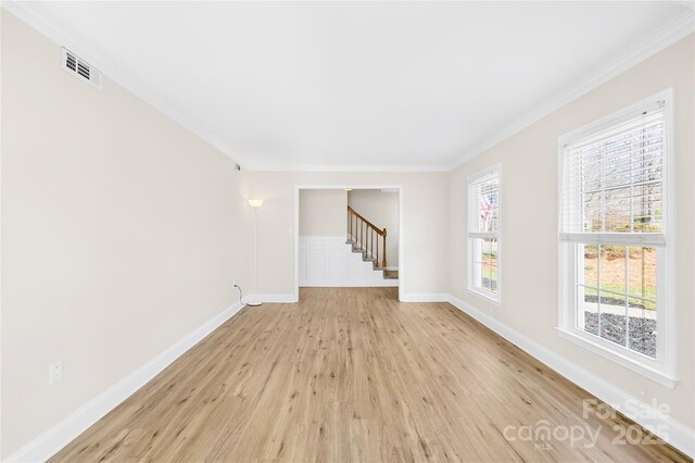 1133 Bloom Wood Ln, Matthews, NC 28105 - empty room featuring light wood-style floors, crown molding, and stairs