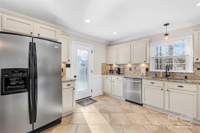 1133 Bloom Wood Ln, Matthews, NC 28105 - kitchen with stainless steel appliances, ornamental molding, backsplash, light stone counters, and decorative light fixtures