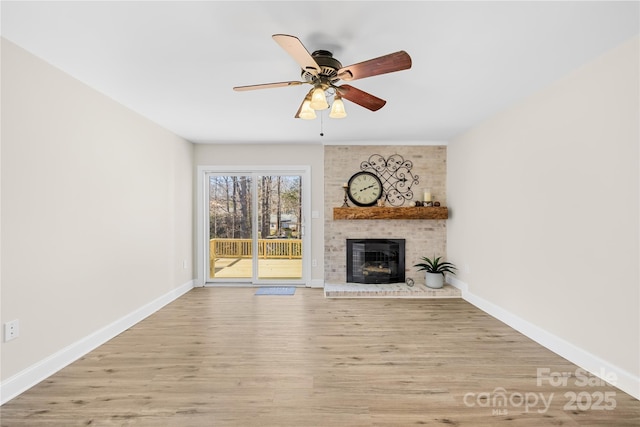 1133 Bloom Wood Ln, Matthews, NC 28105 - unfurnished living room with wood finished floors, a brick fireplace, and ceiling fan