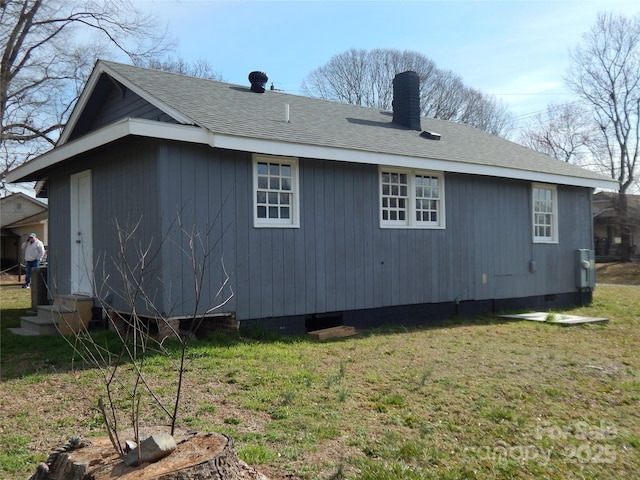 view of side of property with a lawn