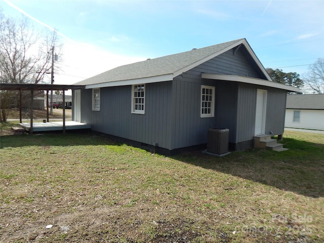 view of property exterior with central air condition unit and a lawn