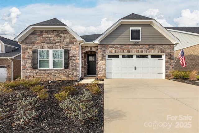 view of front of home featuring a garage, roof with shingles, and driveway