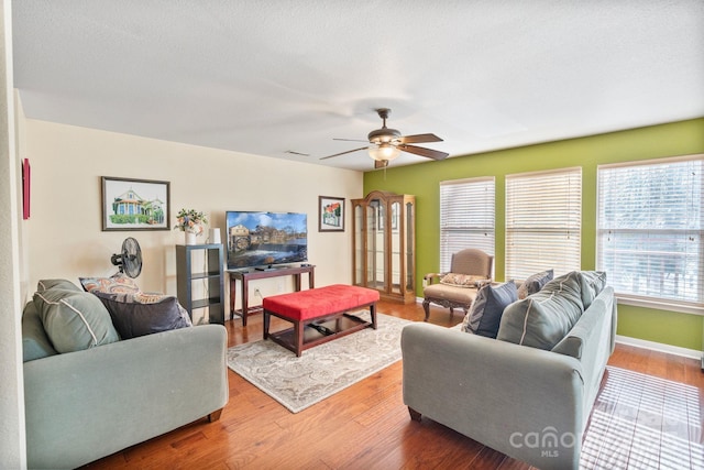 living room with hardwood / wood-style flooring and ceiling fan