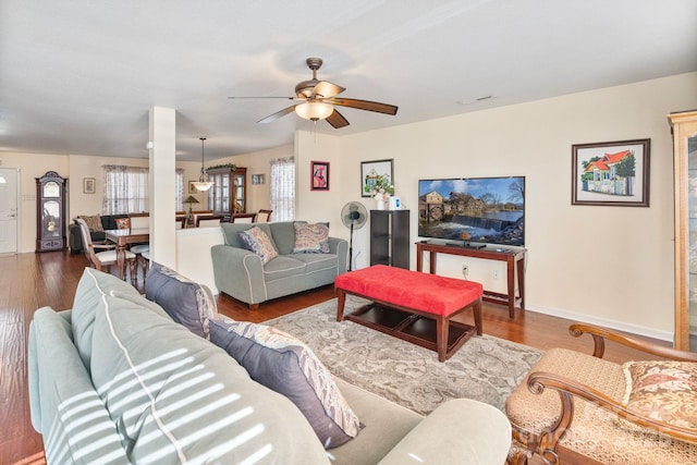 living room with a healthy amount of sunlight, hardwood / wood-style flooring, and ceiling fan