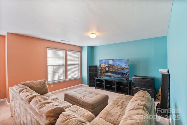 carpeted living room featuring a textured ceiling