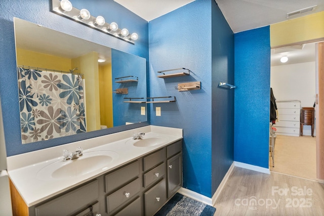 bathroom featuring vanity and wood-type flooring