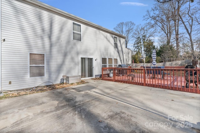 rear view of house with a deck and a patio area