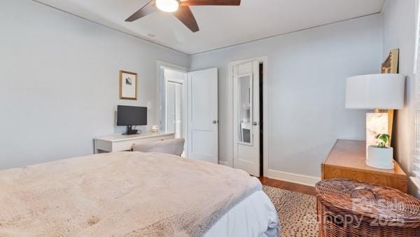 bedroom with baseboards, a ceiling fan, and wood finished floors