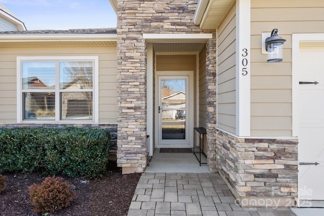 view of exterior entry featuring stone siding