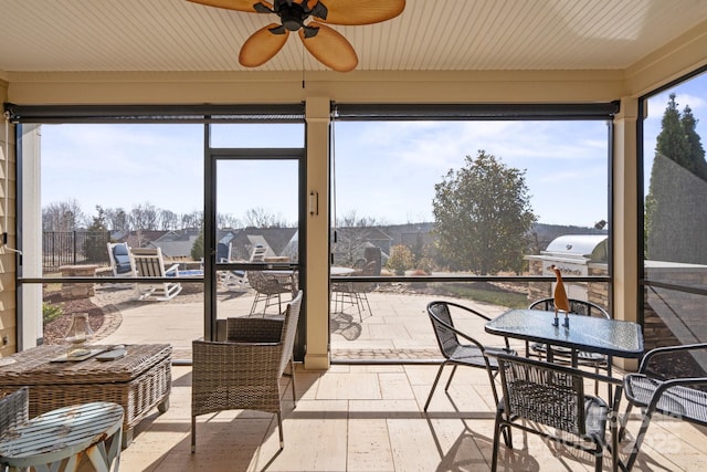 sunroom with a ceiling fan