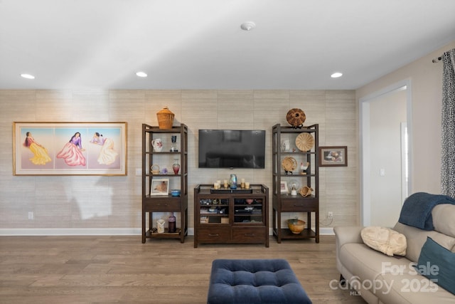 living area featuring recessed lighting, baseboards, and wood finished floors