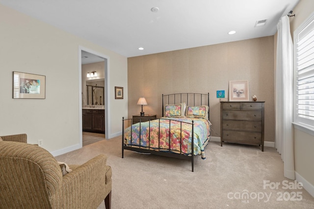 carpeted bedroom with recessed lighting, ensuite bath, visible vents, and baseboards