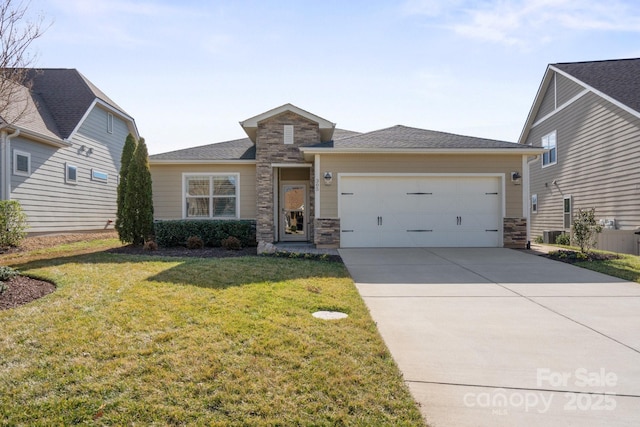 view of front of house with a front yard, stone siding, driveway, and an attached garage